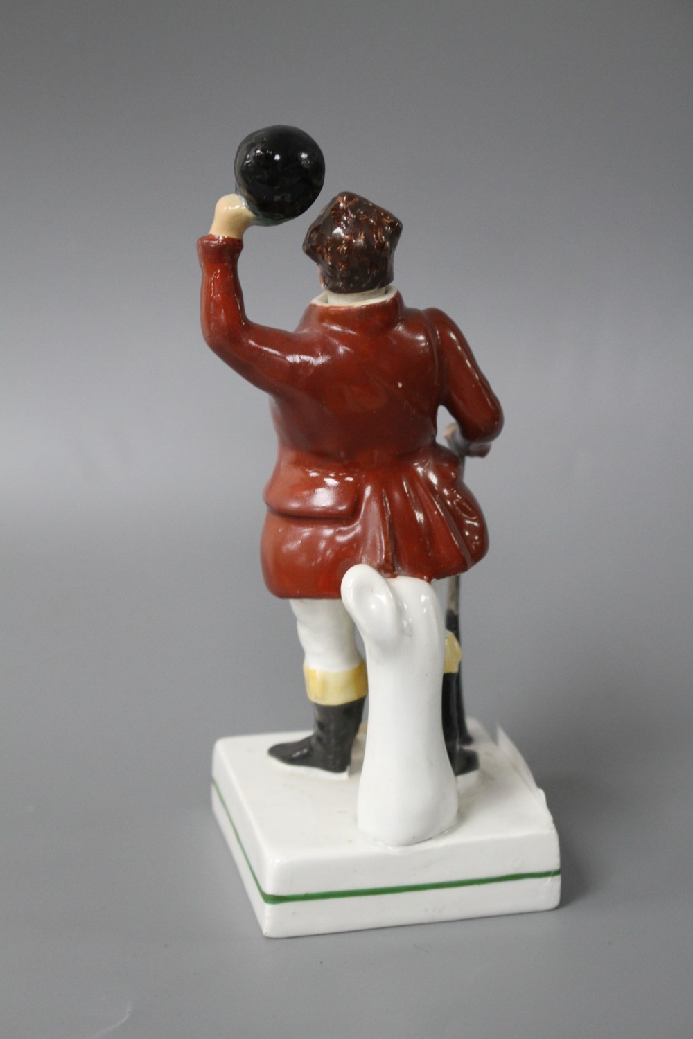 A 19th century Staffordshire figure of a huntsman with stoppered head and square base, height 17cm